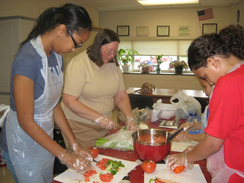 women preparing food on a table